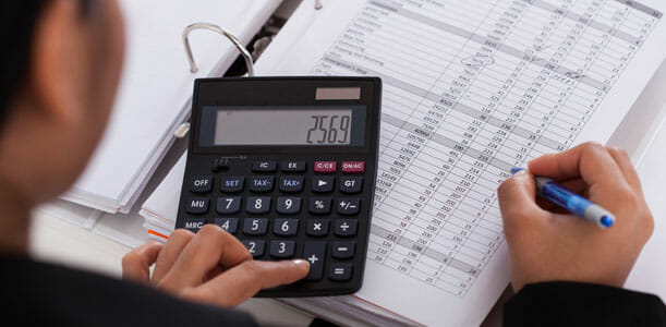 Woman Budgeting on Calculator